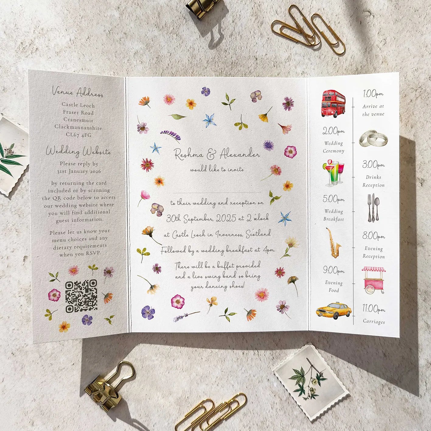 Floral wedding invitation with event details on a textured surface