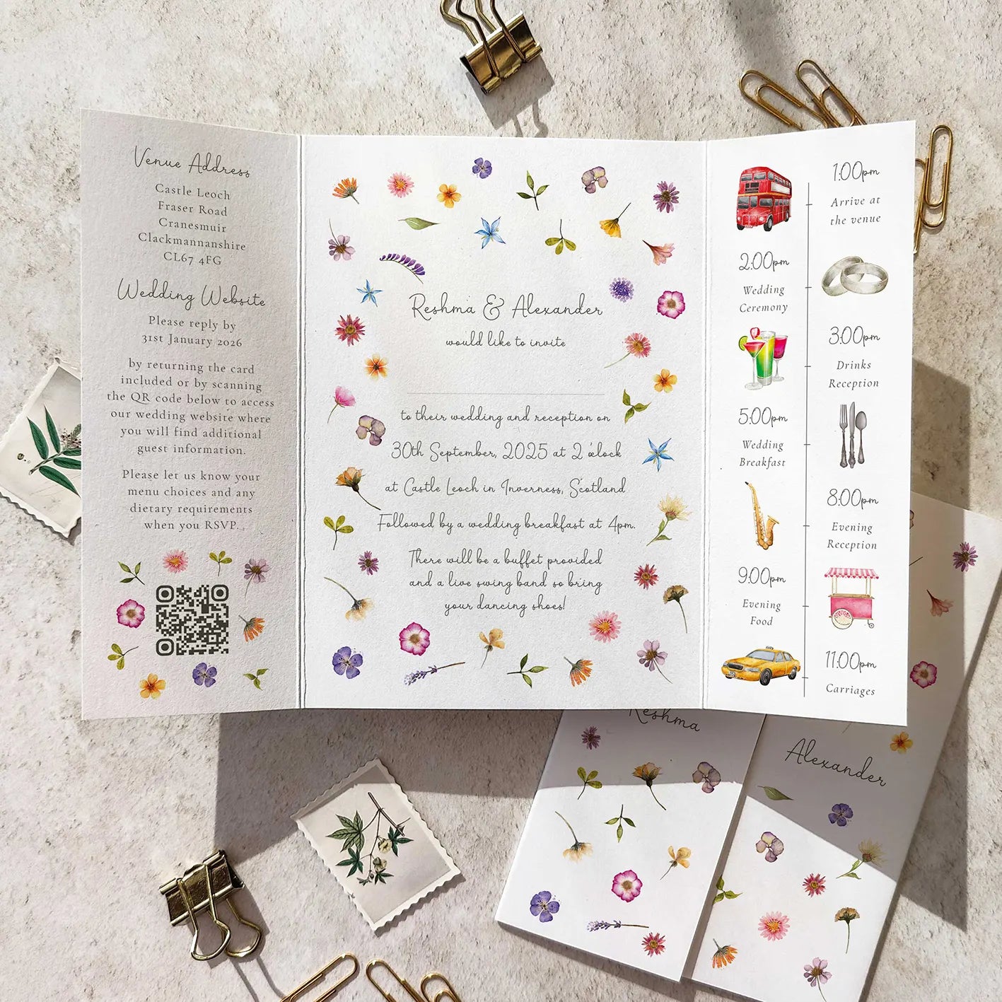 Floral wedding invitation with QR code on a textured surface