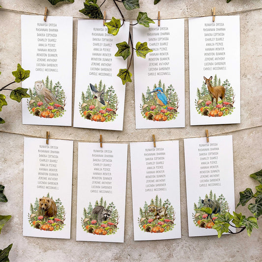 Autumn Woodland-themed table plan cards with animals and plants on a textured surface.