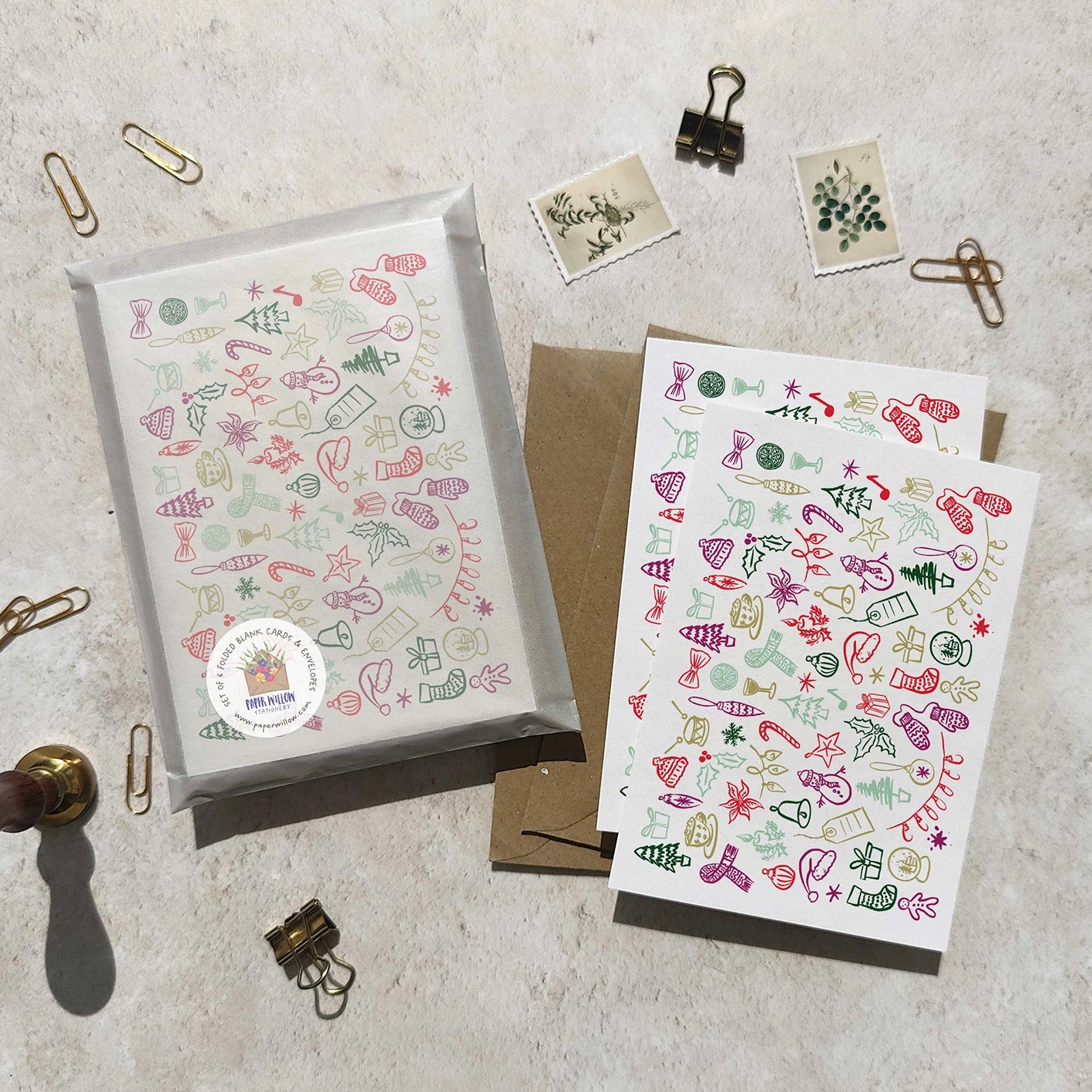 Holiday-themed greeting cards with decorative patterns on a textured surface.
