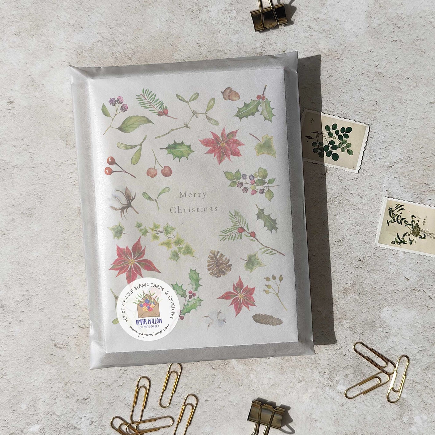 Christmas-themed card with decorative elements on a textured surface