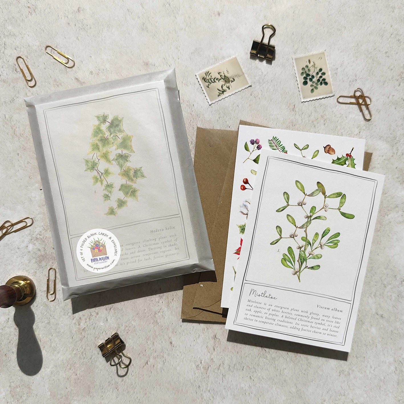 Set of botanical cards with greenery illustrations on a textured surface.