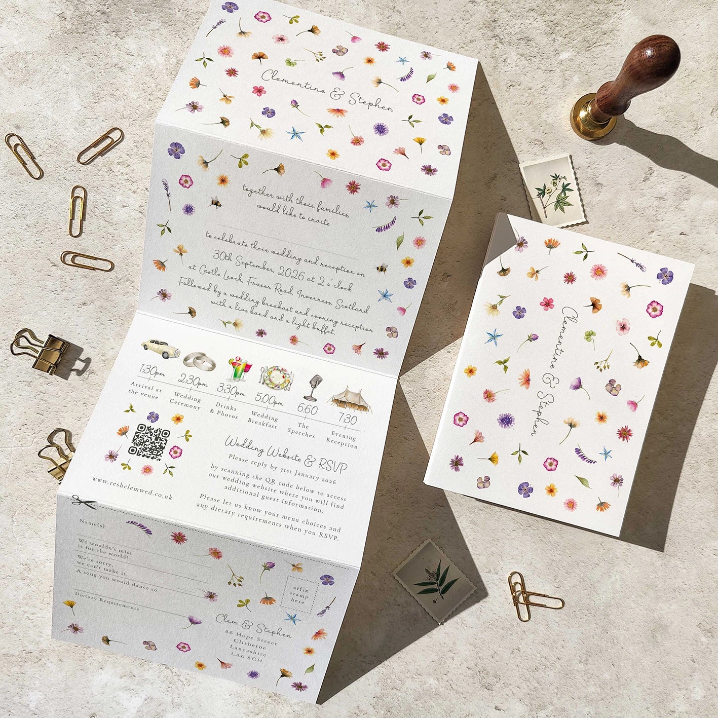 Wedding invitation set with floral design on a textured surface