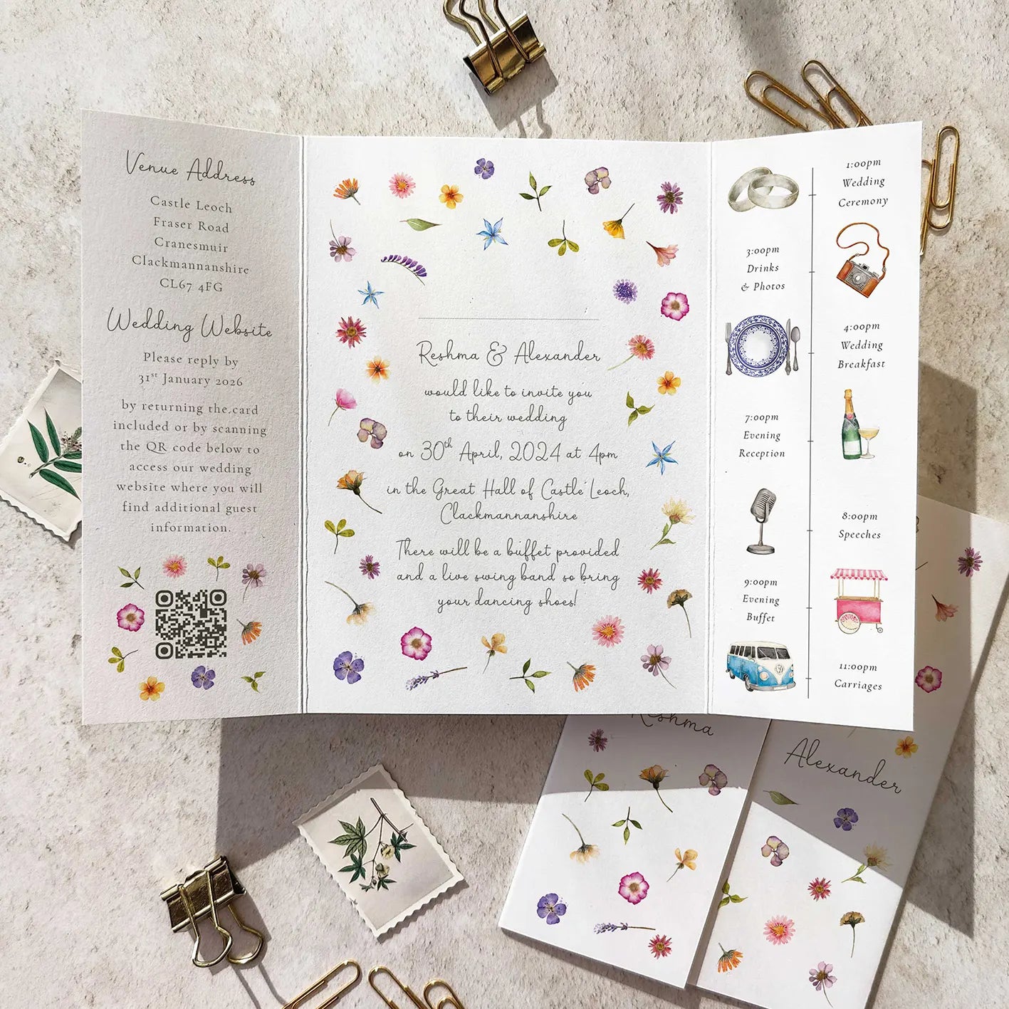 Wedding invitation card with floral designs and text on a textured surface