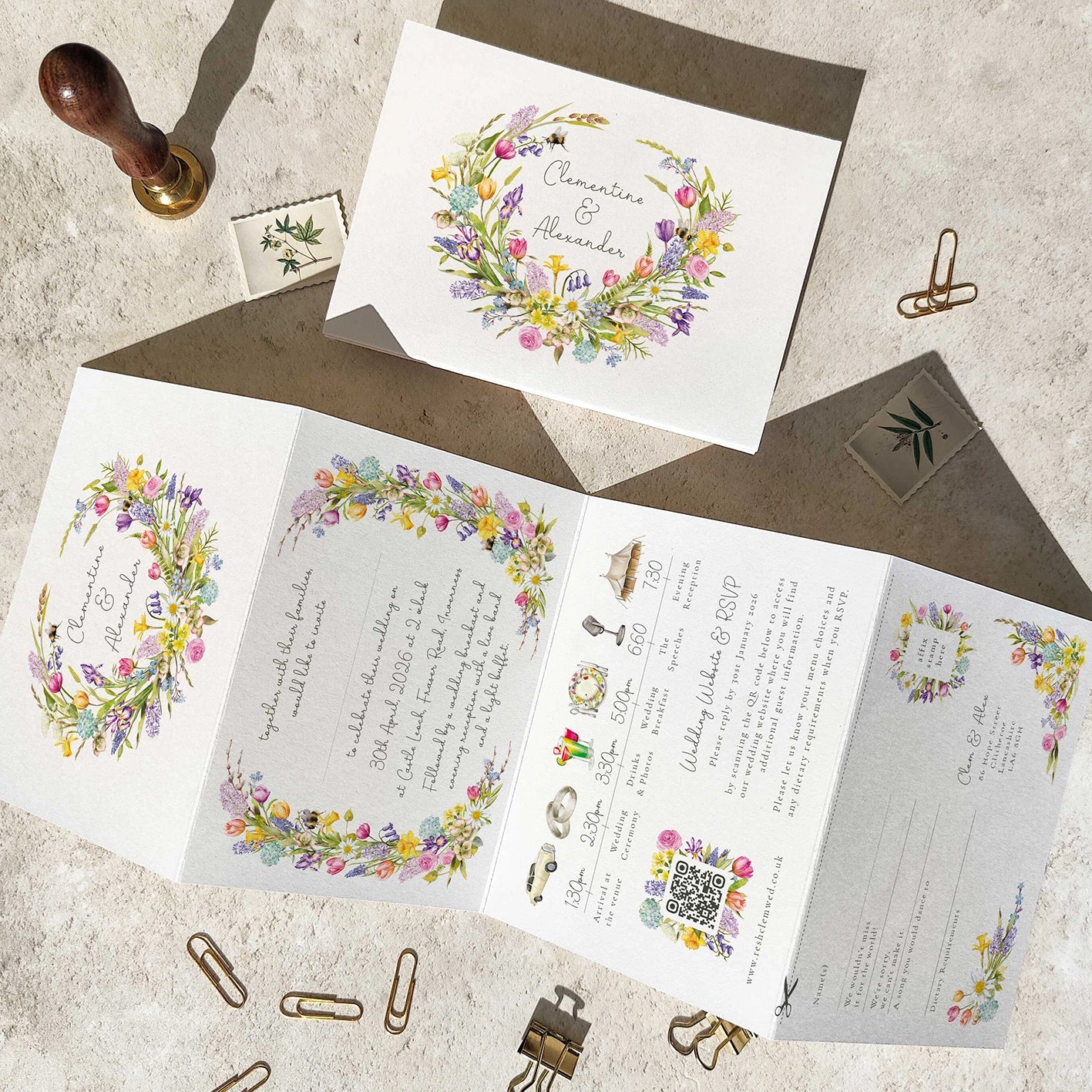 Wedding invitation set with floral designs on a textured surface