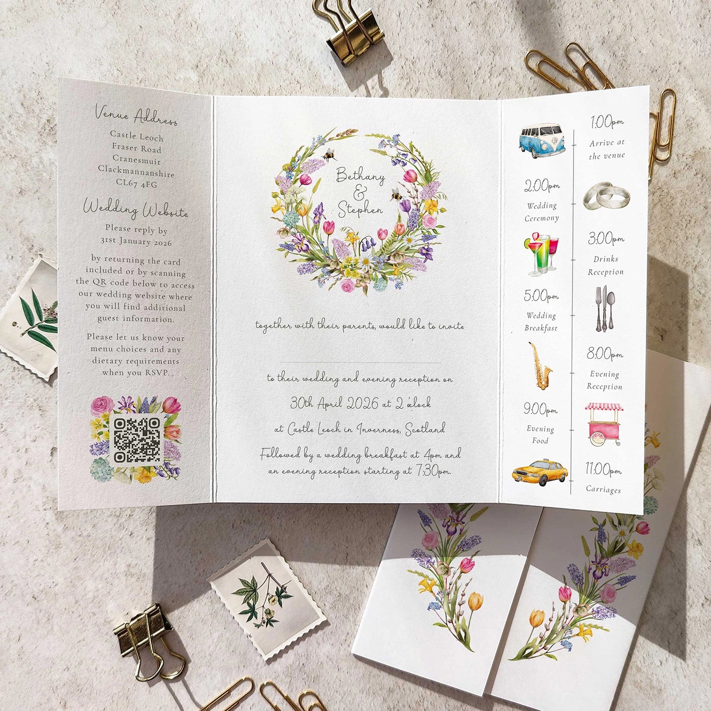 Wedding invitation card with spring flowers design and event details on a textured surface.