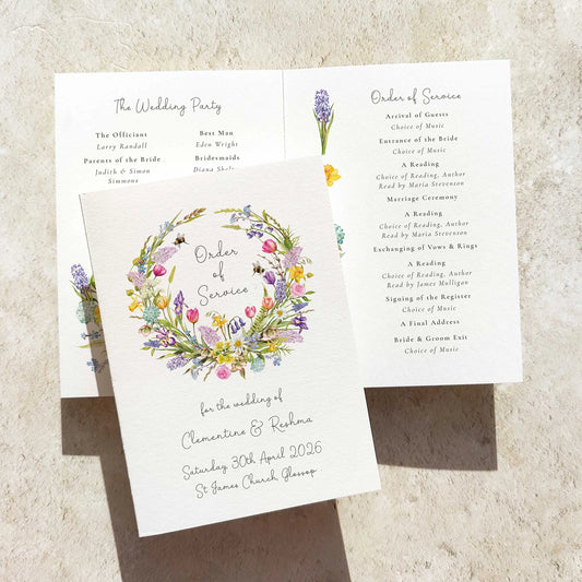 Wedding order of service with floral design on a textured surface