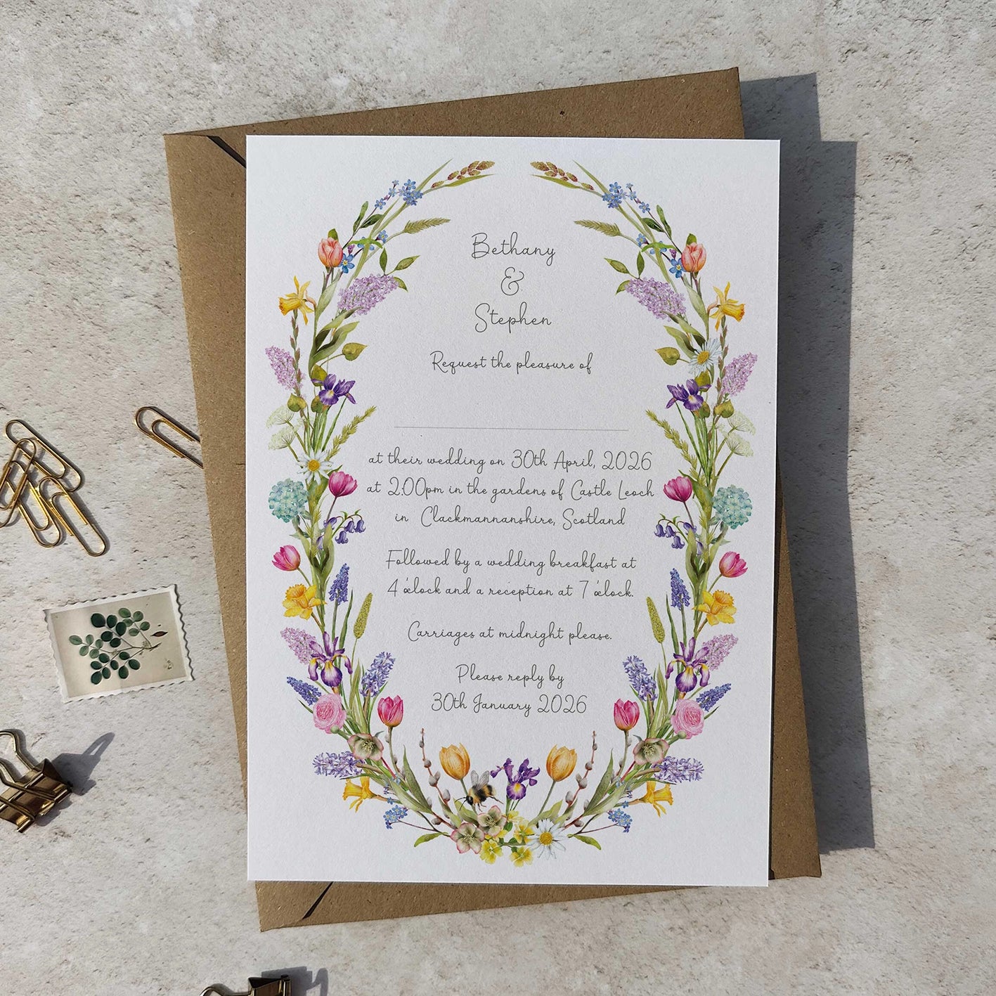 Wedding invitation card with floral design on a textured surface