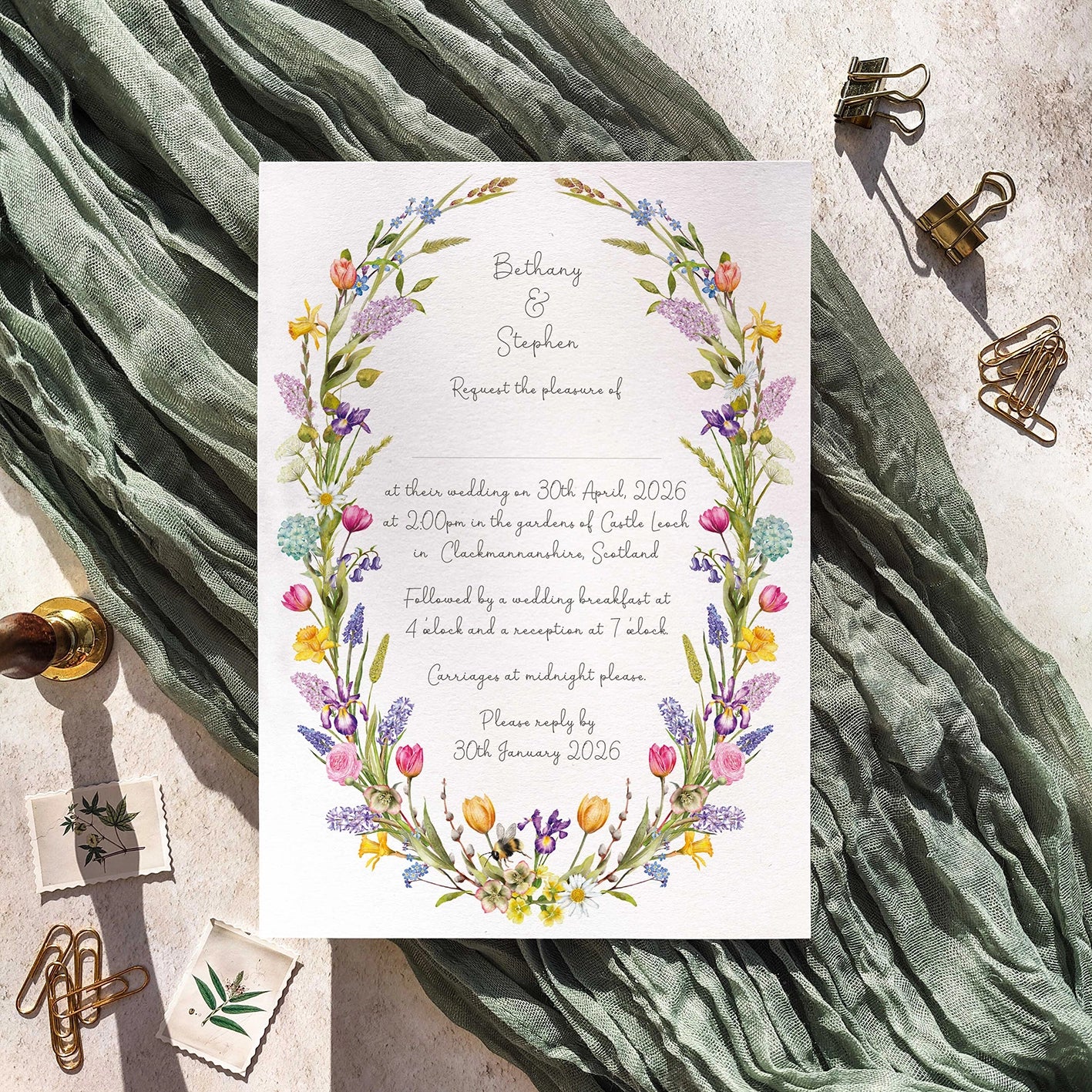 Wedding invitation card with floral design on a textured fabric background
