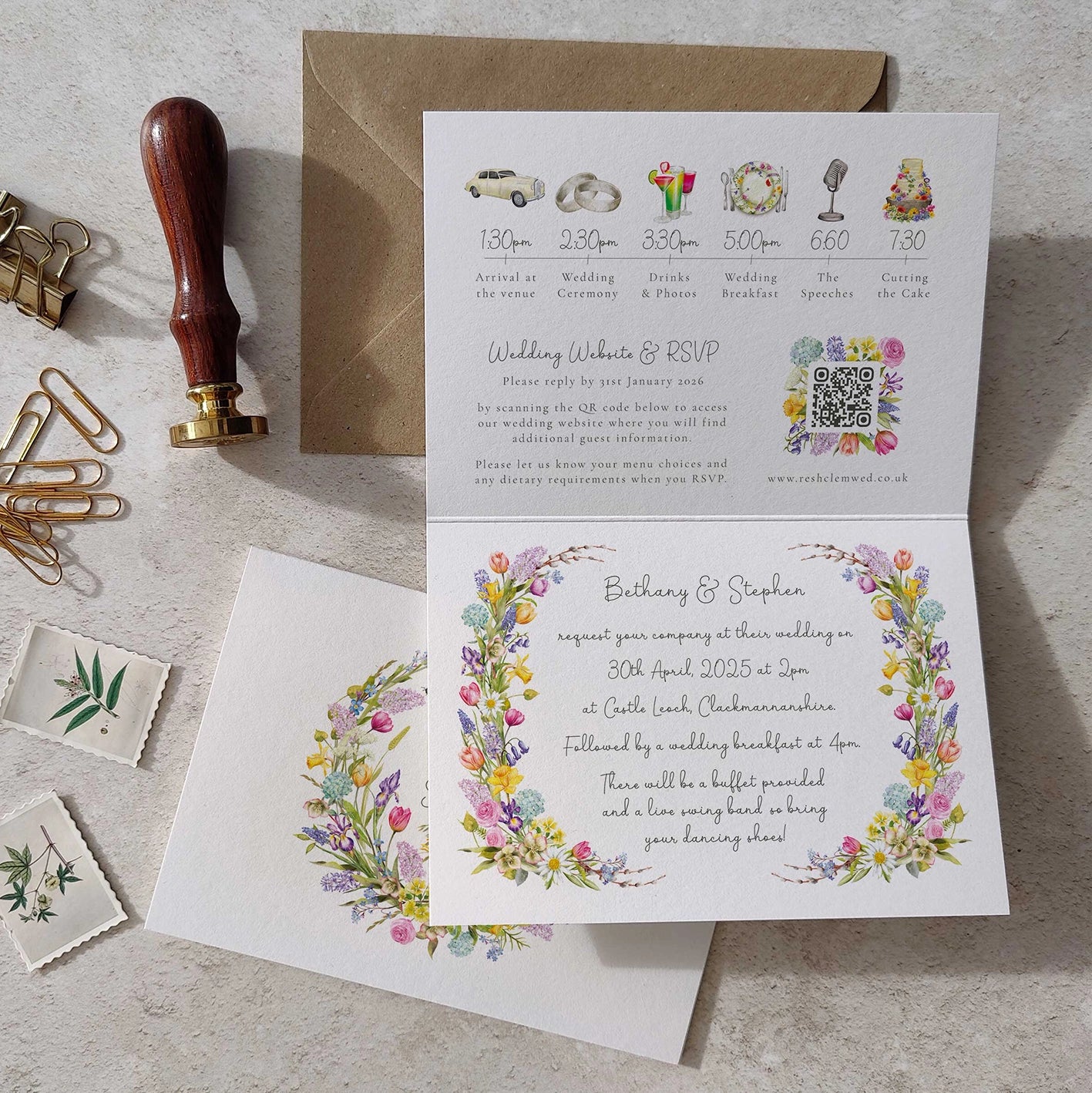 Wedding invitation card with floral design, envelope, and wedding timeline on a textured surface.