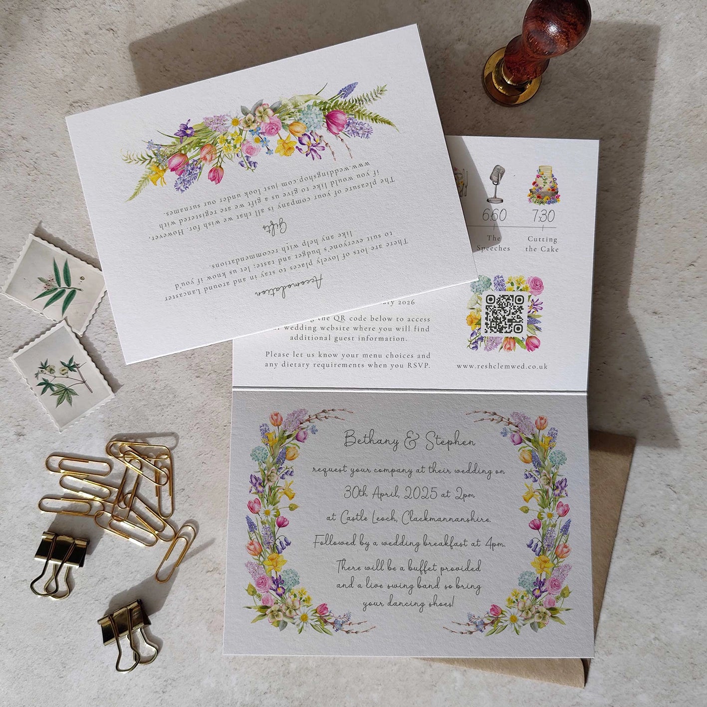 Wedding invitation set with floral design on a textured surface