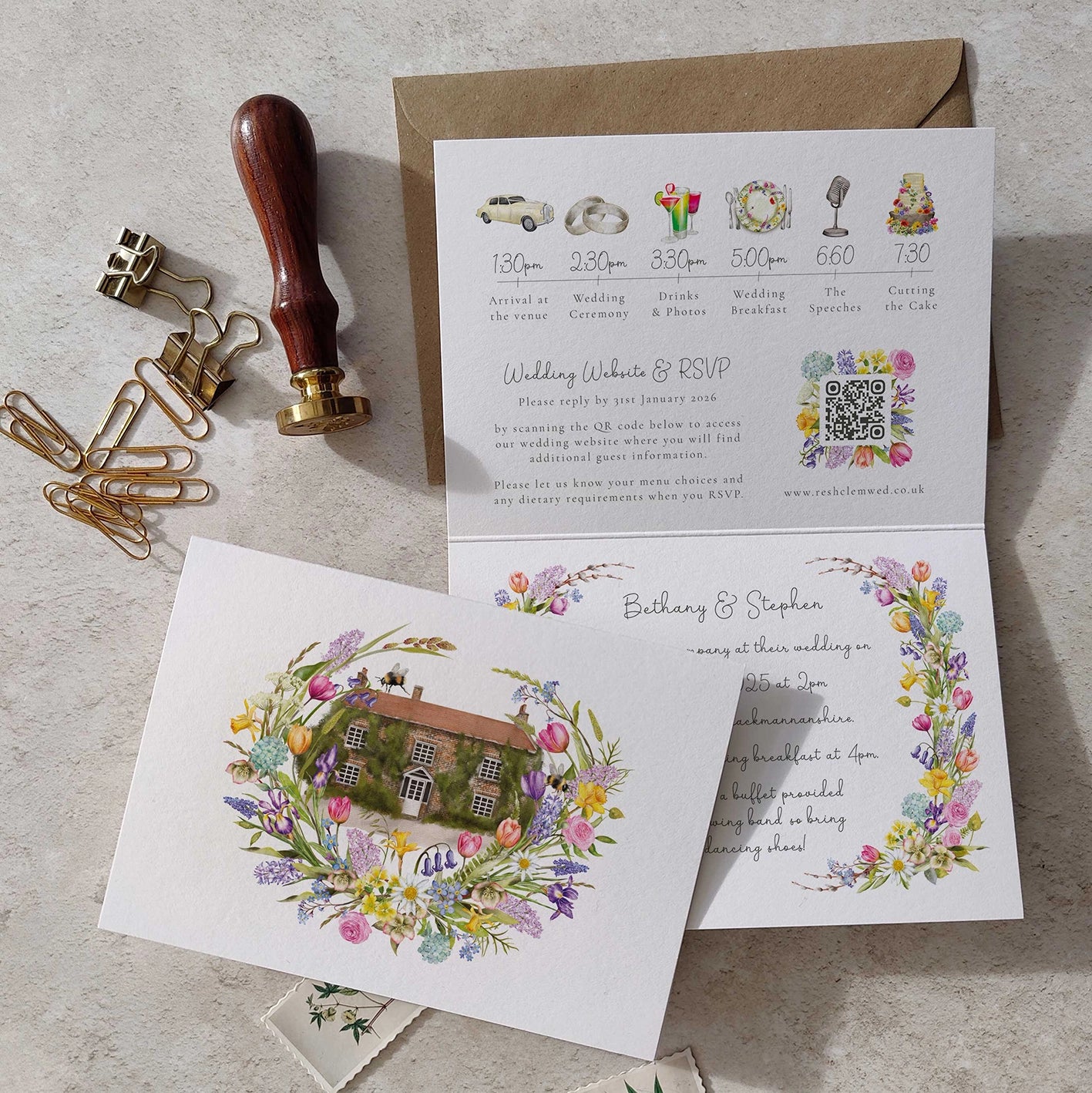 Wedding invitation card with floral design and envelope on a textured surface