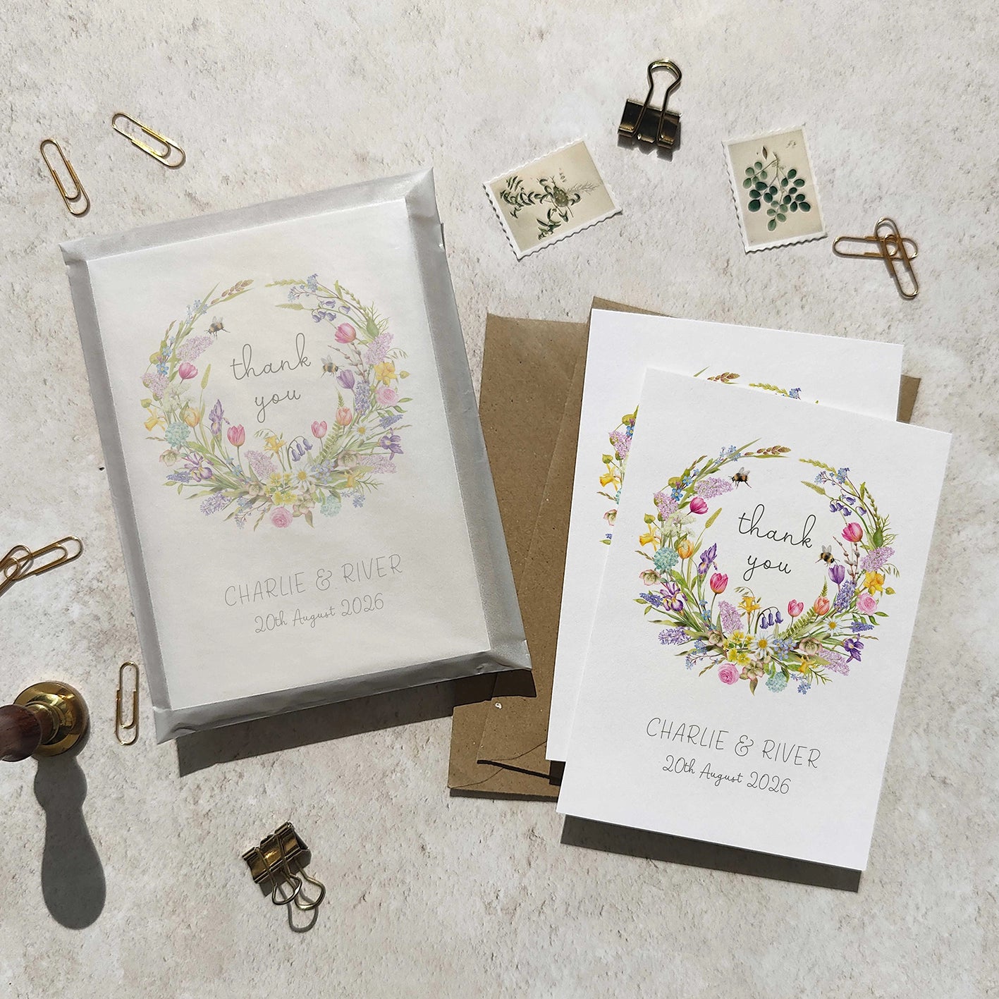Floral 'thank you' cards with personalized text on a textured surface.