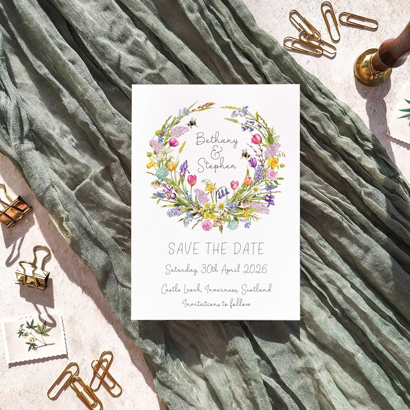 Save the date card with floral design on a textured fabric background