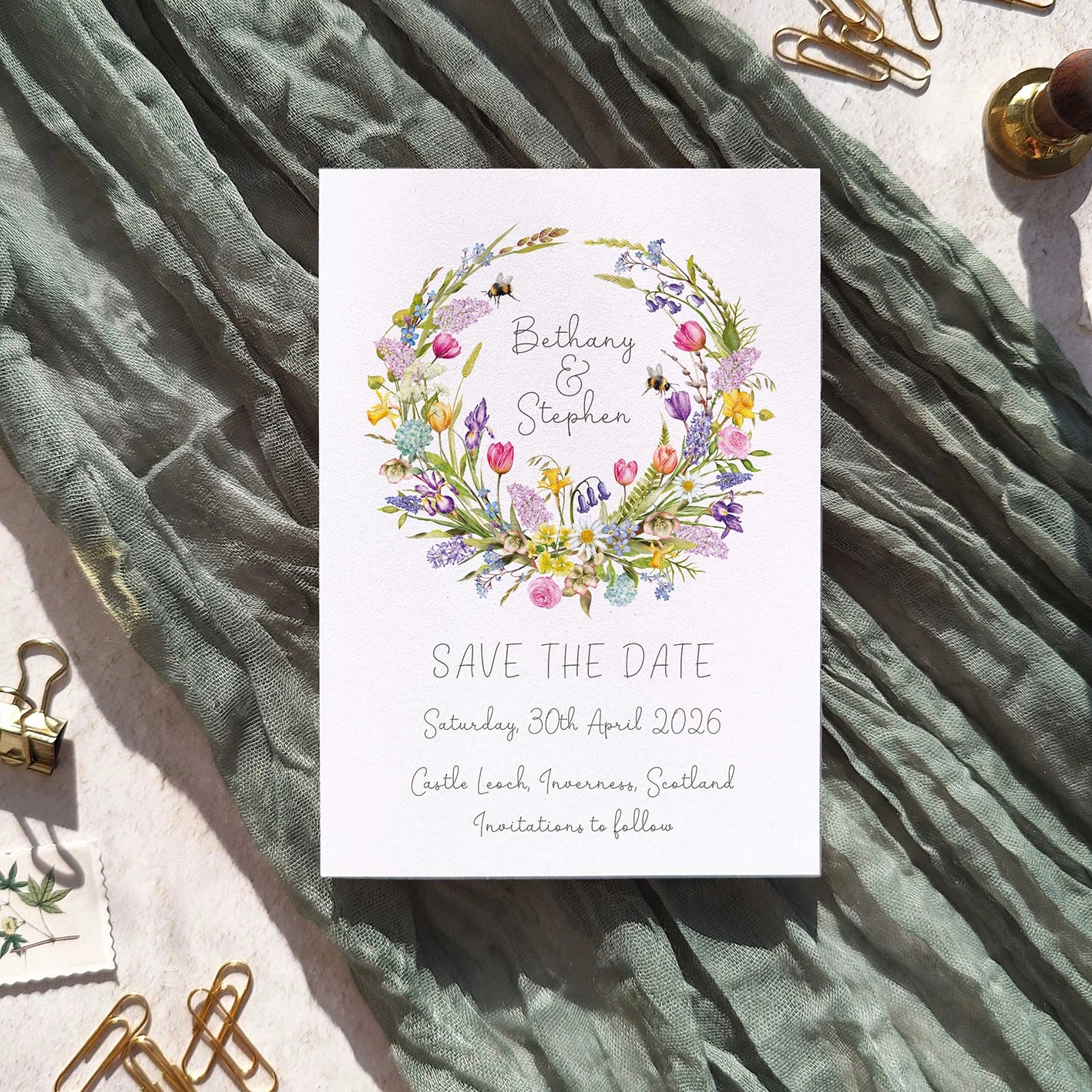 Save the date card with floral design on a textured fabric background