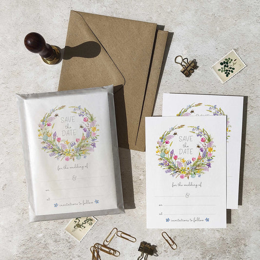 Spring floral Save the date set with 'Save the Date' cards and envelope on a textured surface.