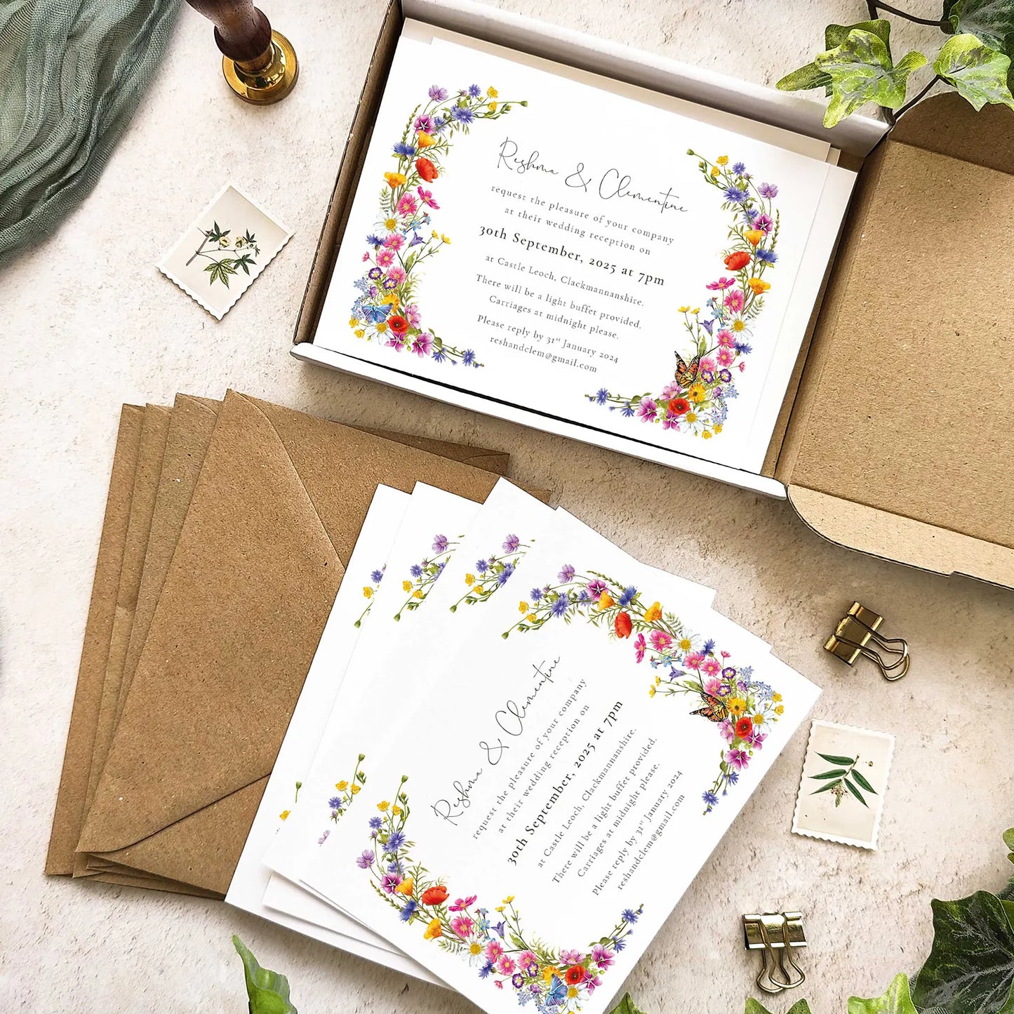 Floral wedding invitations with envelopes on a textured surface