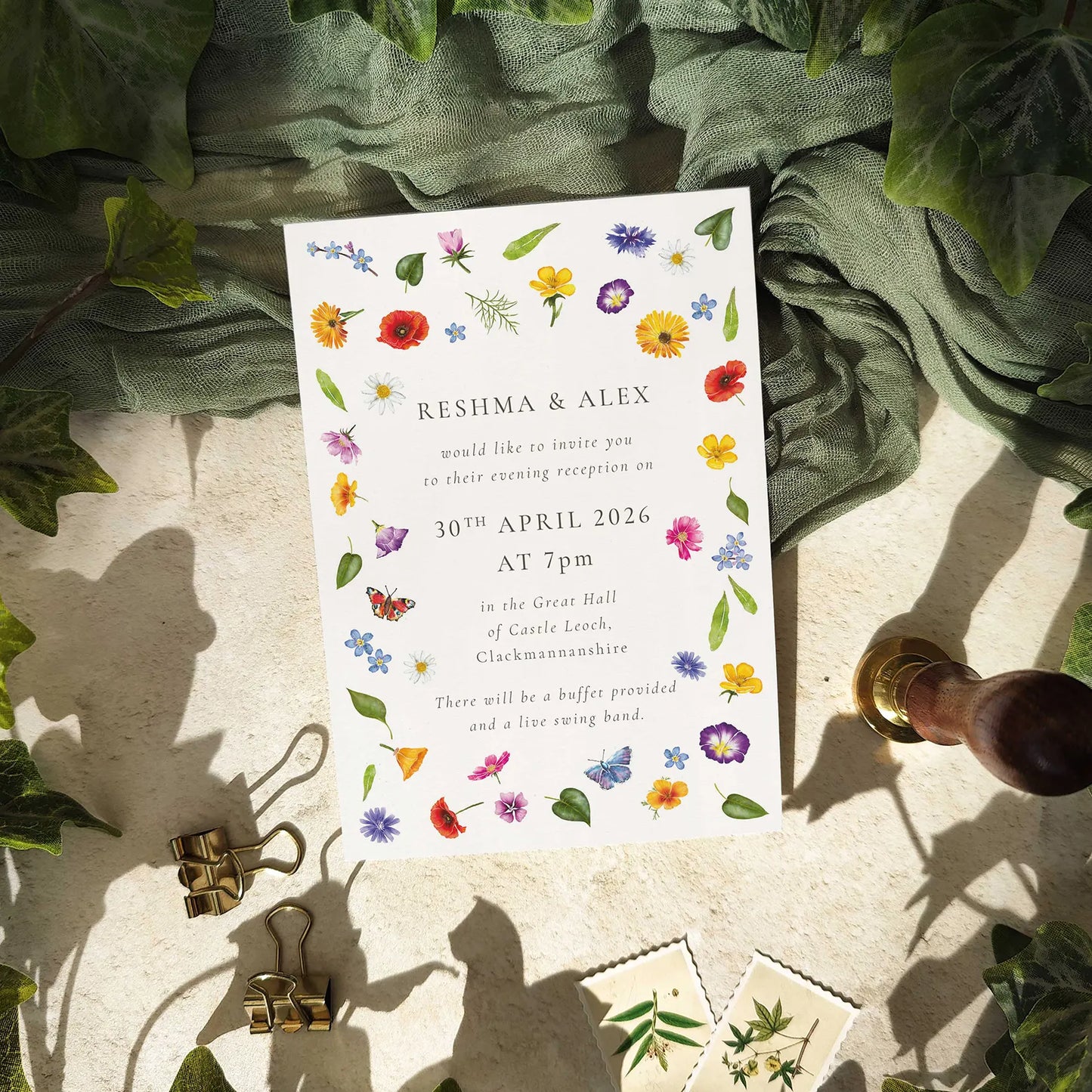 Floral wedding invitation with RSVP card on a decorative background