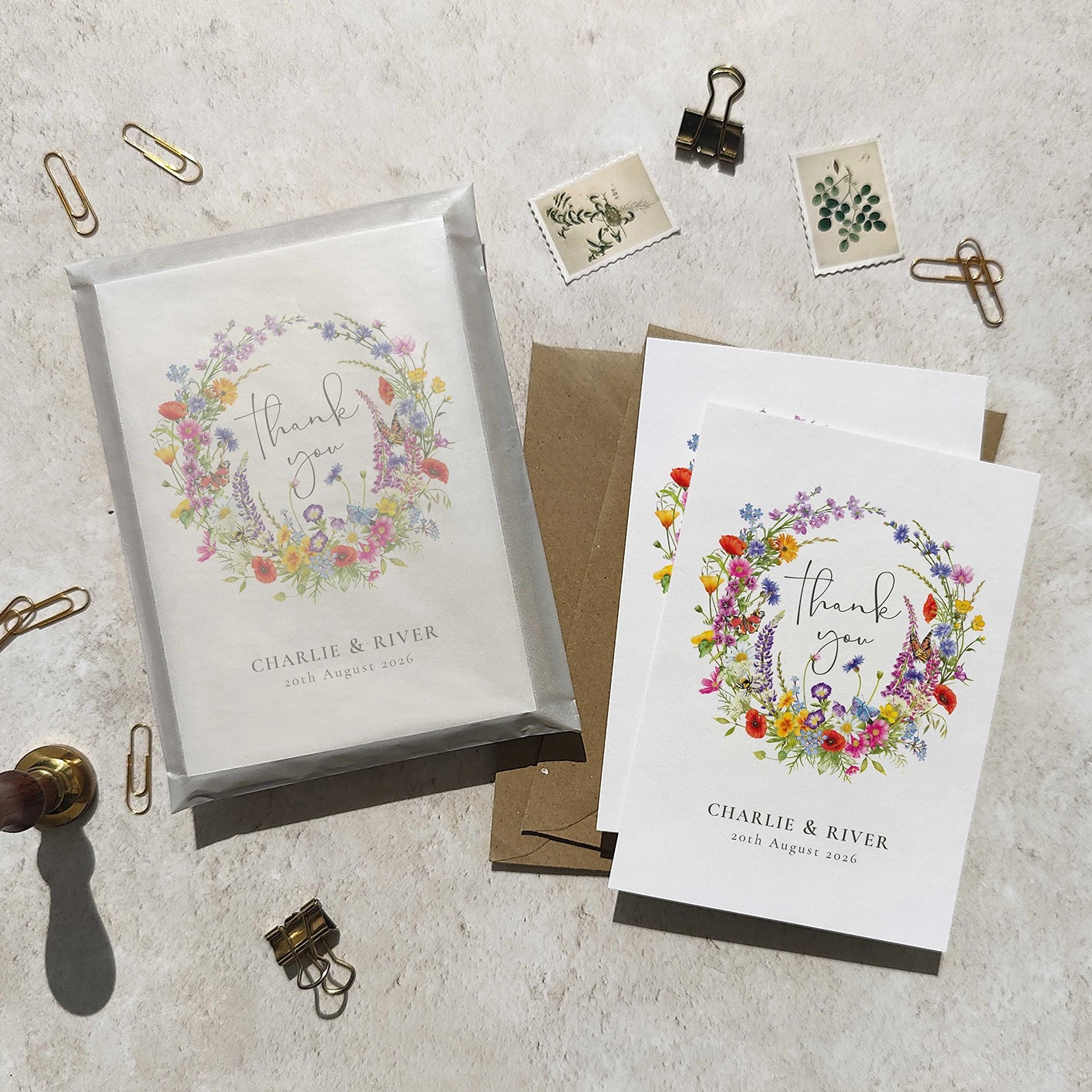 Floral thank you cards with personalized text on a textured surface.