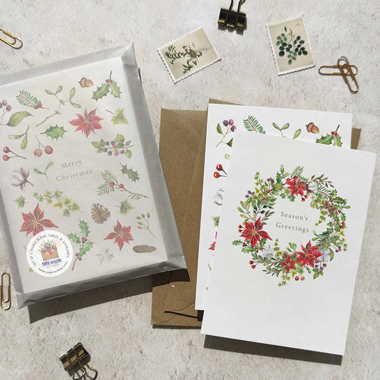 Set of Christmas-themed greeting cards with decorative designs on a textured surface.