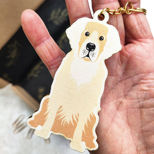 Dog-shaped keychain held in a hand with a blurred background