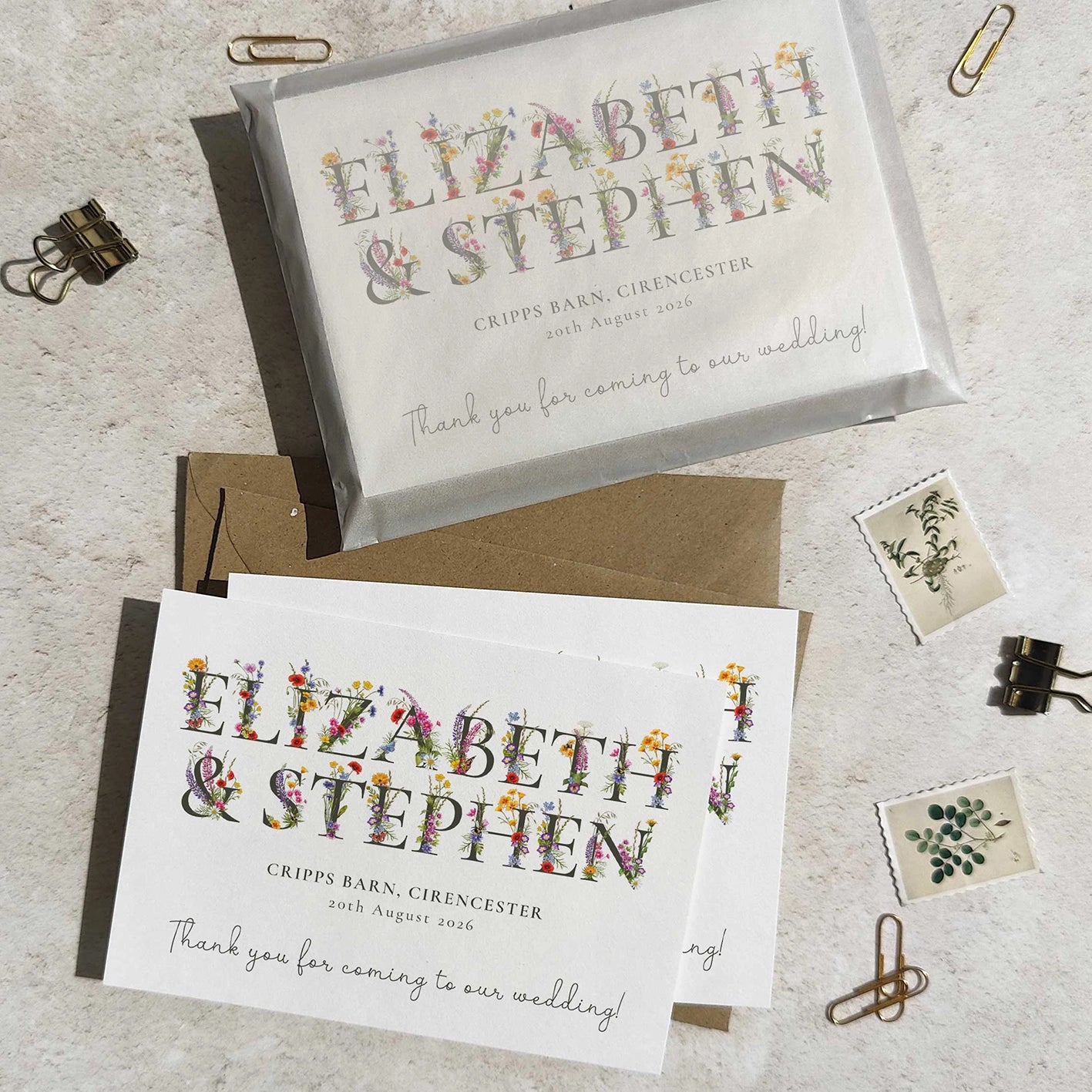 Wedding thank you cards with floral text on a textured surface.