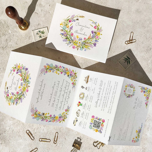 Wedding invitation set with floral designs on a textured surface