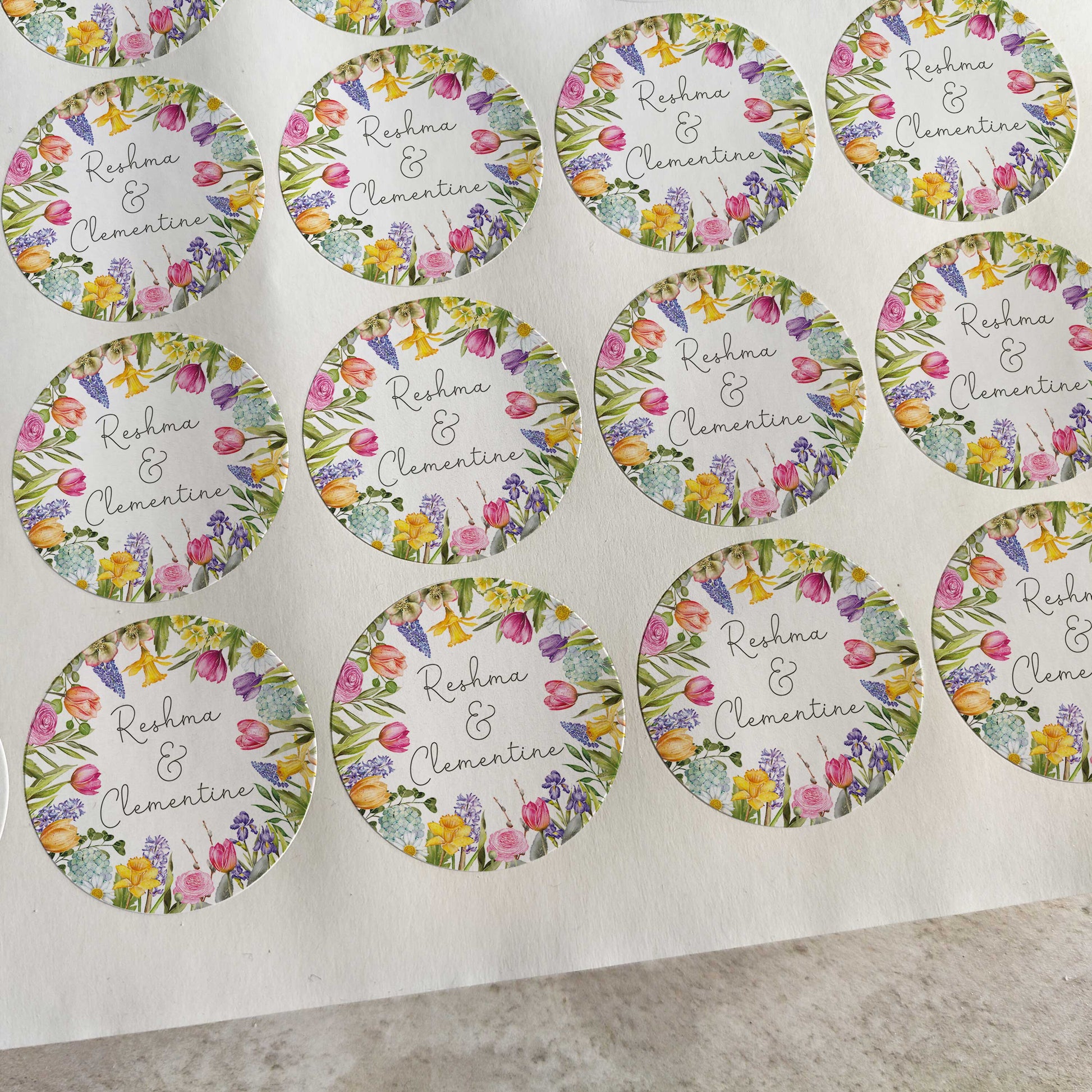 Sheet of round stickers with floral designs and text on a white background
