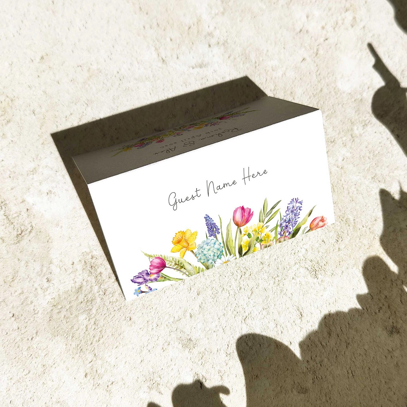 Floral design on a card with a blank space for text, placed on a textured surface.